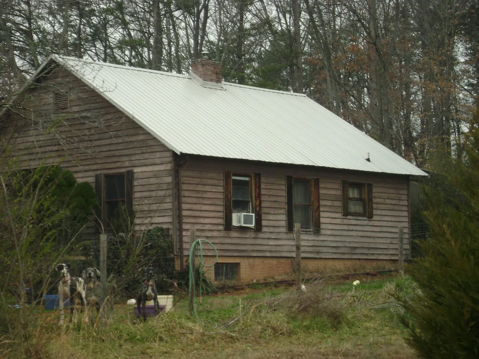 White metal roof on an old wood sided farmhouse, from a Metal Roof Installation job in West Sunbury
